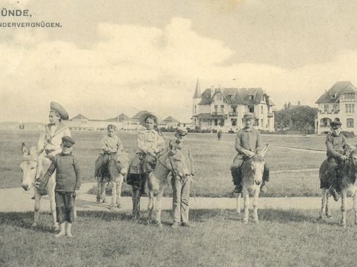 Historisches Foto aus Travemünde mit Kindern und Eseln auf einer Wiese